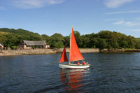 sailing holidays in scotland, stay in log cabins beside a loch