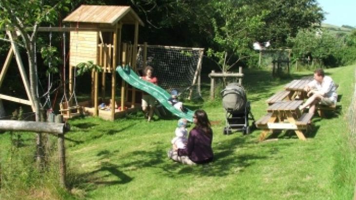 Self-catering country cottage with play area, Wendy House, sandpit, swings, slide, toddlers kick about area adjacent to the orchard